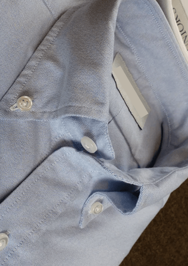 a dress shirt in a light blue color Oxford cloth button-down style