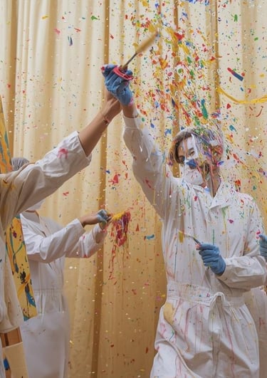 art-studio-with-backdrop-cream-curtains-and-group-of-people-are-throwing-paint-and-making-art