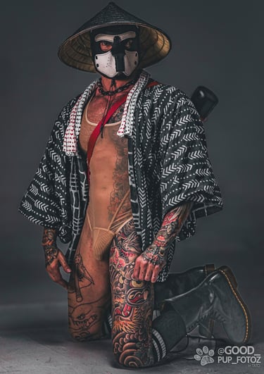 Tattooed man in a pup mask, Haori Jacket, and a dǒulì conical hat.