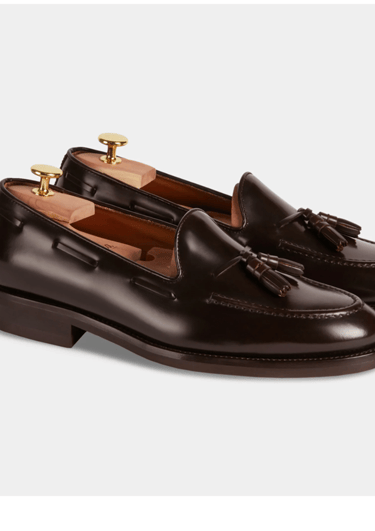 a pair of brown leather tasselled shoes