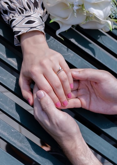 a man and woman holding hands on a table