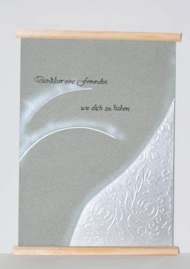 a greeting card with a white background and a silver foiled card
