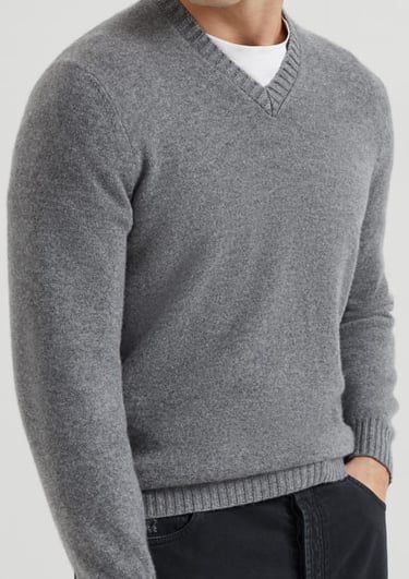 a man in a grey sweater and black pants