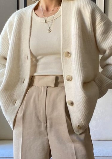 a woman in a white sweater and pants with a white sweater and a white sweater
