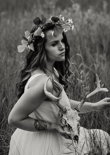 a woman in a dress with a deer skull headdress