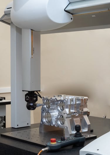 CMM with indexable head probing system inspecting a prismatic machined component. 