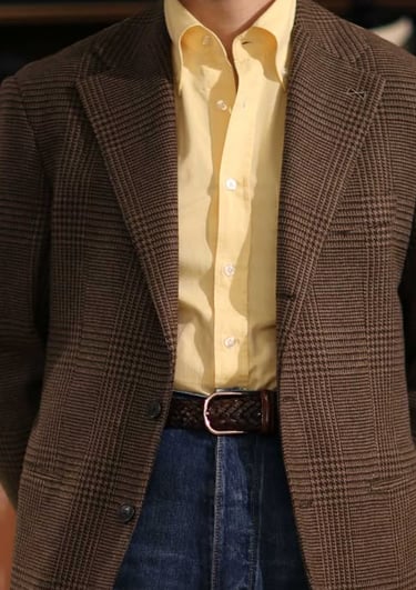 a man in a suit and tie dyes a yellow shirt