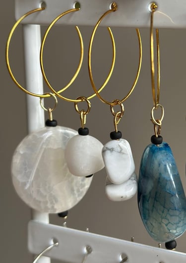 Rosevale Accessories handmade gemstone wine charms on jewelry display