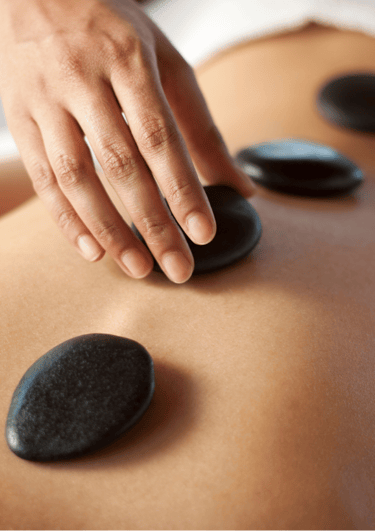 Hotstone rugmassage aangeboden door Medisch Pedicure Grote Berg, ideaal voor stressverlichting.
