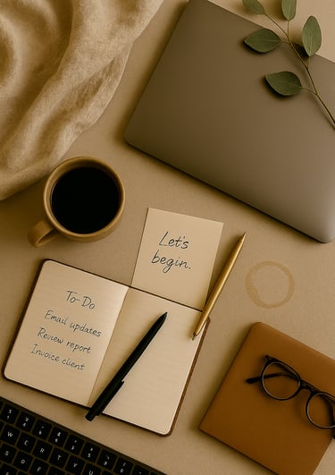 Neutral-toned desk with coffee, notebook, pens, and laptop