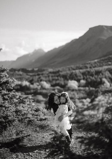 a woman in a white dress is holding a child