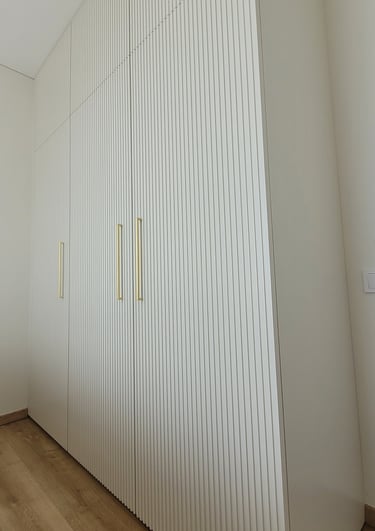 Bespoke wardrobe with Fluted fronts add texture and depth while keeping the look soft and elegant
