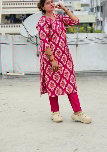 a woman in a pink dress and white shoes