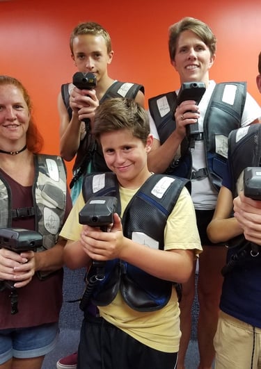 family posing for laser tag