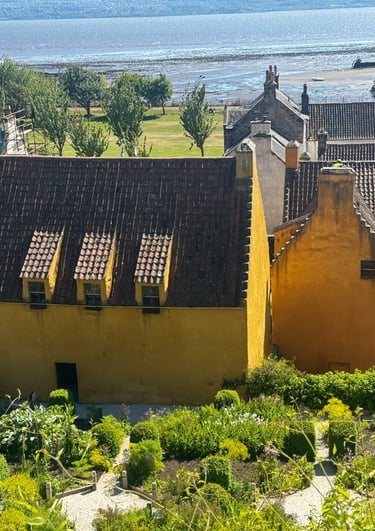 Gardens at rear of Culross Palace with the Firth of Forth in the distance