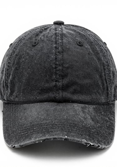 A pair of sleek sweatpants hanging on a minimalist rack beside a sporty cap.