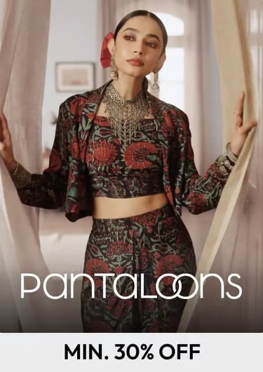 Model wearing a printed Pantaloons ethnic co-ord set with a cropped jacket and traditional silver jewelry.