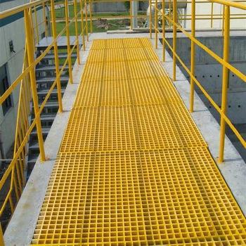 FRP GRP yellow fiberglass handrails installed on an industrial walkway with grating, designed for co