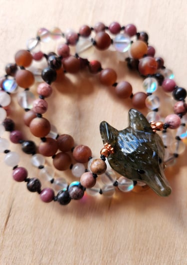 Hand-knotted gemstone mala necklace with 108 beads, created by Tina Medina for spiritual meditation and energy healing