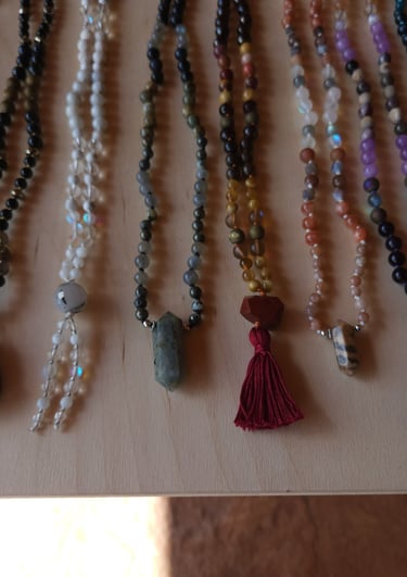 Hand-knotted gemstone mala necklace with 108 beads, created by Tina Medina for spiritual meditation and energy healing