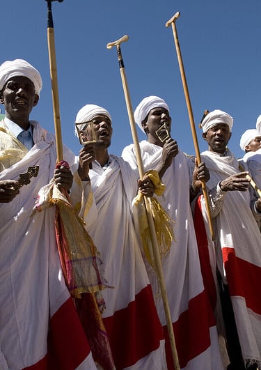 a group of men in white and red robes and white robes