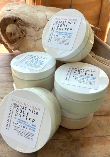 Stacked jars of Giddy Goat Farms Cocoa Butter Cashmere Goat Milk Body Butter for natural skincare.