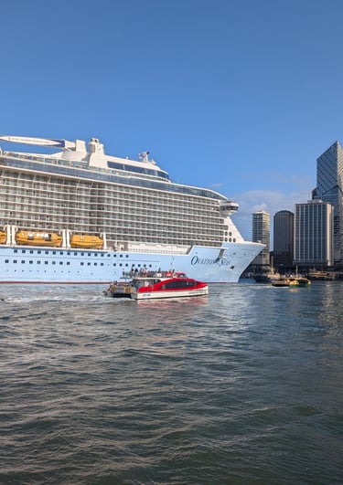 ferry next to cruise ship in Sydney Harbor