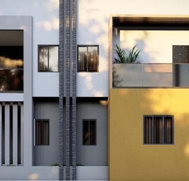 a yellow and white building with two balconies