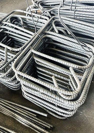 Stacks of precision machine-bent rebar stirrups ready for delivery