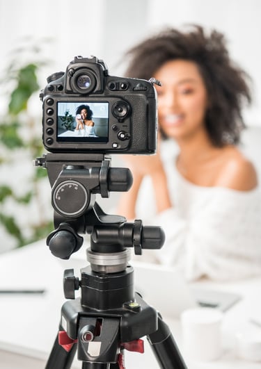 a woman is taking a video camera and recording a video of a woman in a