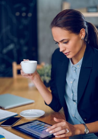 a woman in a suit and a cup of coffee