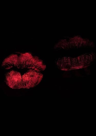 two lips on a black background with red lipstick