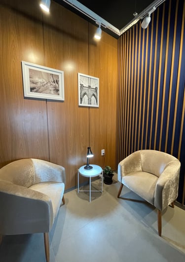 a living room with a chair and a table fairtrade office