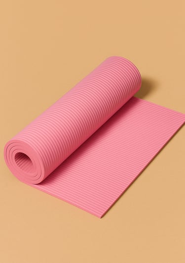 Rolled pink yoga mat on a warm beige surface
