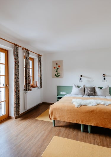 a bedroom with a bed and a couch