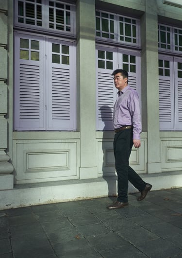 man in purple shirt walking on the street | olio my shop