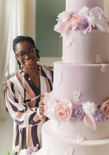 portrait of wedding cake designer with a luxury wedding cake at chateau de bouffemont near paris