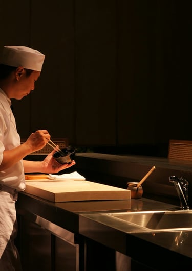 Chef is cooking food in the dark kitchen