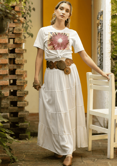 a woman in a long skirt wearing a white t shirt with the design Abstract Pink Daisy Light on a Pink 