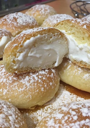 a pile of doughnuts with a bite out of it