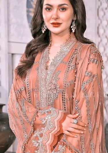 a woman in a designers pink embroidered dress 