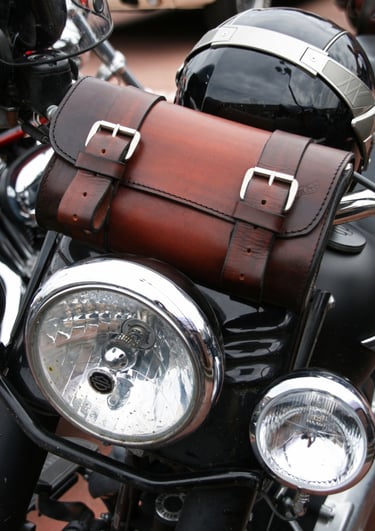 Borsa per attrezzi in cuoio marrone di MaxCuoio appoggiata su una moto