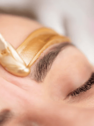 a woman with a gold colored eyeliners and a gold colored eyeliners