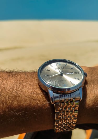 a man's wrist watch on a wrist