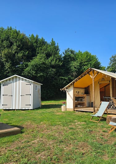 a tented out in a field with a hot tub and a hot tub