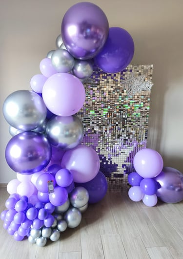 a bunch of balloons and balloons are arranged on a table