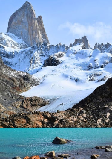 Turquoise glacial lake at the base of snow-capped Mount Fitz Roy peak in Patagonia, Argentina.