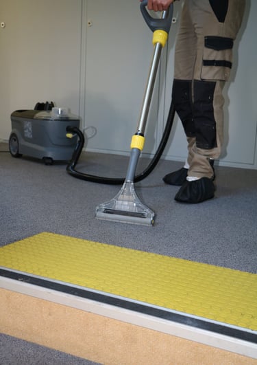 a man is using a vacuum cleaner to clean the carpet