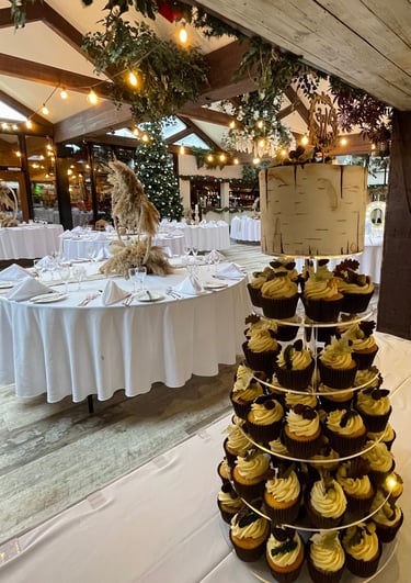a wedding cake with cupcakes and cupcakes on a table