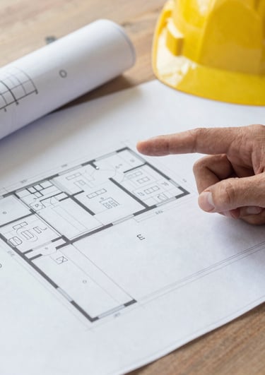 Cozy wooden cabin surrounded by pine trees at sunset.